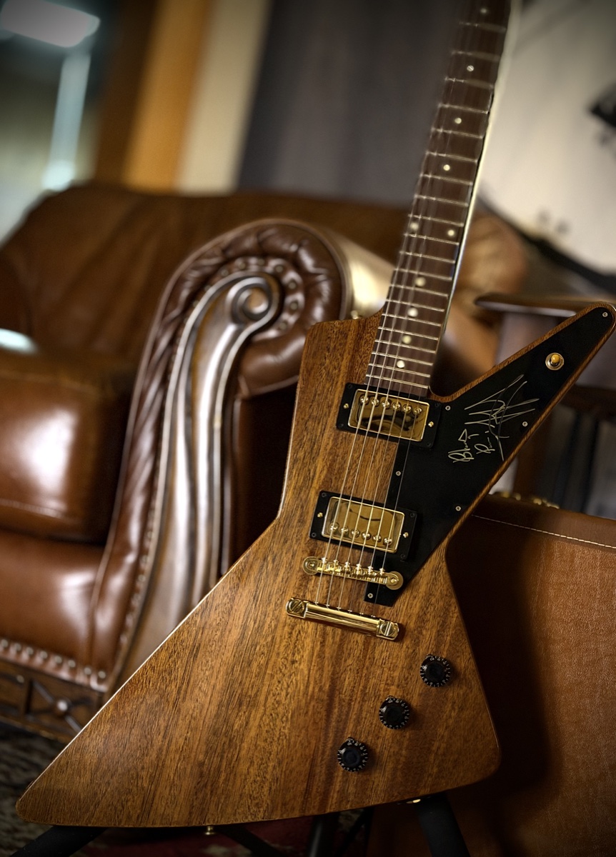The giveaway Gibson Futura with the signed black pickguard fitted, standing in the Moore Guitars showroom